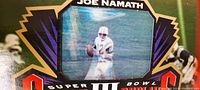 Close-up photo showing the 3D lenticular image of Joe Namath in mid-throw on the football field, with text reading 'JOE NAMATH' and 'SUPER BOWL III' along with colorful graphics.