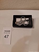 Fox Edge cigar cutter in box on white background with MaxSold lot number 47