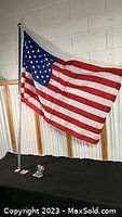 Single American flag displayed on pole and bracket setup showing full flag detail and size.