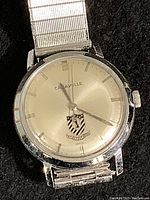 Close-up of the vintage Caravelle watch face showing the dial, indices, hands, and crest logo.