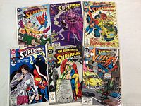 Six comic books displayed together, showing various colorful superhero cover artworks.