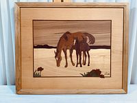 Framed wood inlay art depicting mare and foal in natural tones.