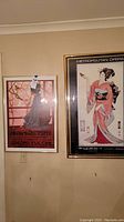 Two framed posters on a wall, Metropolitan Opera on right and Madame Butterfly on left.