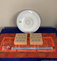 Overview of all lighting items showing the round ceiling light, two small wooden deck lights, and long LED light strip on patterned cloth