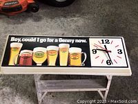Full front view of rectangular Genesee lighted beer clock showing beer glasses artwork and clock face.