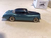 Side view of metallic light blue 1951 Chrysler K-310 diecast model showing car profile and roof color.