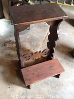 Side angle showing the carved side panel and kneeling bench of the pine prayer desk.