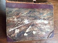 Front cover showing marbled paper and leather binding