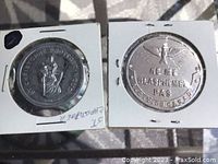 Metal religious token with St. Christopher image and inscription.