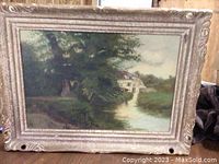 Full view of the framed landscape oil painting showing the house, stream and trees.