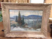 Frontal view of oil painting with carved wood frame