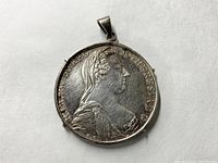 Obverse side of 1780 Austrian Thaler coin pendant, showing profile bust portrait with Latin inscription.