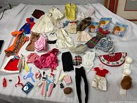 Full layout of Barbie doll clothing and accessories, organized and photographed for condition and completeness.