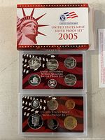 Photo of the complete set in original box with three acrylic cases containing proof coins.