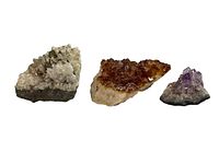 Photo shows three crystal chunks placed side by side on a white surface, highlighting their size and color differences