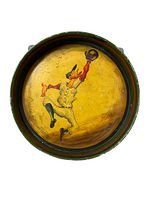 Front view of antique round metal tray showing hand-painted graphic of a baseball catcher in uniform making a catch against yellow background. Green and red painted raised edge visible.