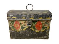 Front view of antique painted metal box showing floral design and metal latch, with visible wear and distress.
