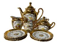 Full view of the Bavienthal tea service set showing teapot, creamer, sugar bowl, teacups, and saucers with gold detailing and painted classical scenes.