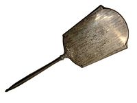 Full length photo of silver plated hand mirror showing overall shape, handle, and tarnish.