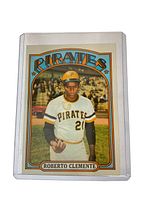 Front of card in plastic top-loader showing Roberto Clemente tossing a baseball on the field