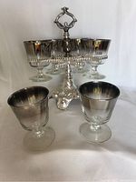 Front view of 6 metallic rim glasses on silver decorative stand, showing glass and stand design.
