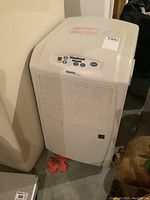 Front view of the white Danby Designer dehumidifier showing vent grille and electronic control panel