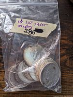 Ten Maple Leaf coins in a clear resealable bag labeled '10 1oz silver maples'
