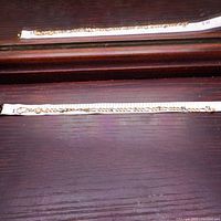 Full bracelet laid against measuring tape showing approximately 8-inch length