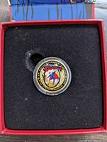 Reverse of gold coin showing colored enamel Superman design and coin specifications