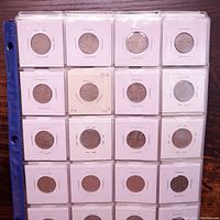 Full binder page of Canadian nickels in 2x2 holders. Coins vary in condition and dates, some inscriptions noted in holders.