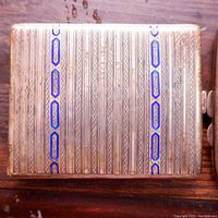 Exterior top view of silver cigarette case with blue enamel vertical stripes