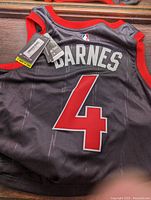 Photo showing back of large Toronto Raptors Scotty Barnes #4 jersey with tags attached