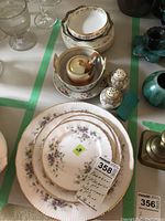 Overview of Paragon Malandi plates, mustard pot, Noritake salt and pepper shakers, and assorted bowls arranged on table