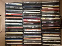 Wide view showing multiple CDs stacked in a bankers box, titles include Dave Brubeck, Sugar Ray, Crazy Town, and more.