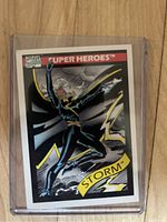 Front of 1990 Marvel Storm trading card showing artwork of character in action pose with lightning effects.