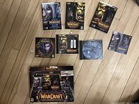 Full view of all Warcraft game items including game boxes, manuals, discs, and original Battle Chest box