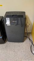 Front view of black Hisense dehumidifier with brand label visible.