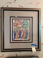 Front view of one piece of framed wall art depicting colorful figures near stylized trees, double matted and in a pewter-like frame.