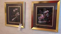 Two signed abstract paintings in gold tone frames hung on a wall side by side.