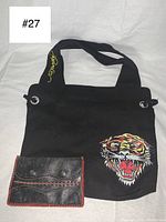 Full view of black Ed Hardy shoulder bag with tiger face and vintage leather wallet.