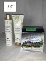 Pantene Hair Volume Multiplier Silicone Free Shampoo and Conditioner with Bamboo bottles alongside Crest 3D Whitestrips Charcoal Mint box showing product and remaining strips.