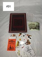 Full view of fortune telling cards, instruction booklet, hand-tooled leather cover, and vintage photos arranged on a surface.
