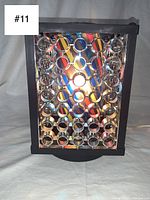 Front view of vintage 1960s kaleidoscope lamp showing multiple round reflective lenses and psychedelic color pattern.