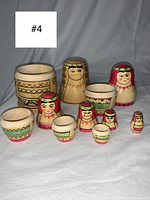 Full set of 10 Russian nesting dolls arranged on a grey cloth background, showing internal nesting parts and sizes.