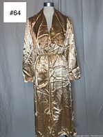 Front view of vintage champagne yellow satin robe on mannequin showing full length, shawl collar, pockets, and rope sash.