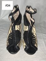 Top-down view of pair of Wittner snake skin peep toe pumps with ankle straps. Shows snake skin pattern and black leather trim.
