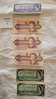 Top view of all six bills including one $10 bill, three $2 bills, and two Centennial $1 bills.