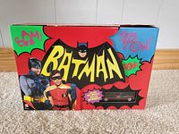 Front view of the colorful Batman TV series DVD set packaging with Adam West and Burt Ward and comic book style graphics