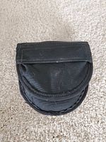 Closed black nylon case for handcuffs, showing flap with Velcro