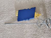 Photo of blue DEP contour gauge with yellow ends and metal screws showing wear.